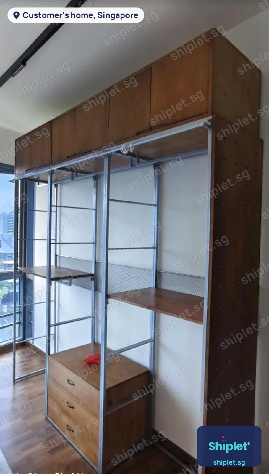Open wardrobe system with a steel frame, wooden top cabinets, shelves and drawers assembled by a window