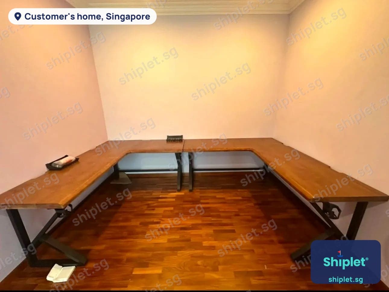 U-shaped wooden desk on steel legs running along three walls of a study