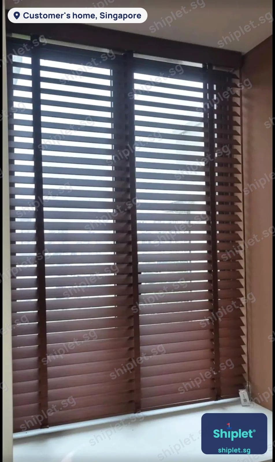 Wooden venetian blinds installed across a bay window in a Singapore home